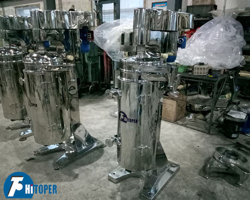 Centrifugeuse tubulaire industrielle pour la séparation liquide, liquide solide et traitement en suspension avec décharge basée sur la densité précise